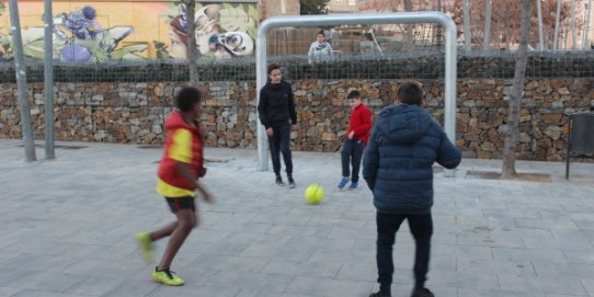 Infants jugant a futbol a la nova porteria instal·lada al passeig de la plaça Major.